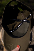 Inside the Olive cotton cap, showing black seam tape with white FOKE branding.
