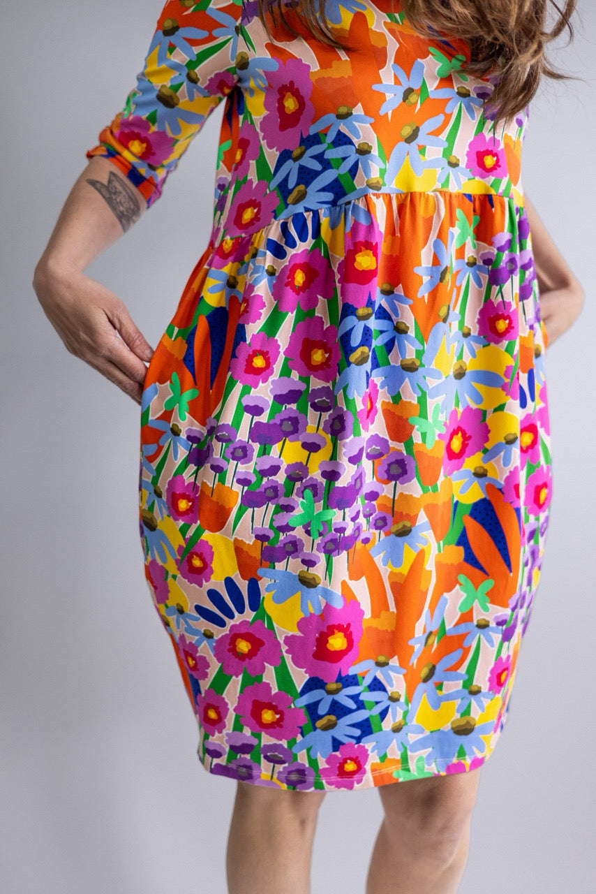 Mid-length view of the REN Dress in Bloomcore showing the relaxed fit and bold floral print.
