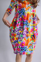 Mid-length view of the REN Dress in Bloomcore showing the relaxed fit and bold floral print.