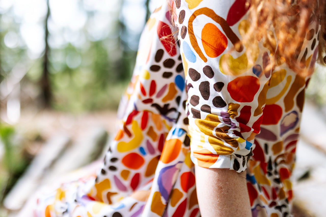 Women wearing colorful patterned dress. Wearable art fashion — bold prints and comfortable fit dress.