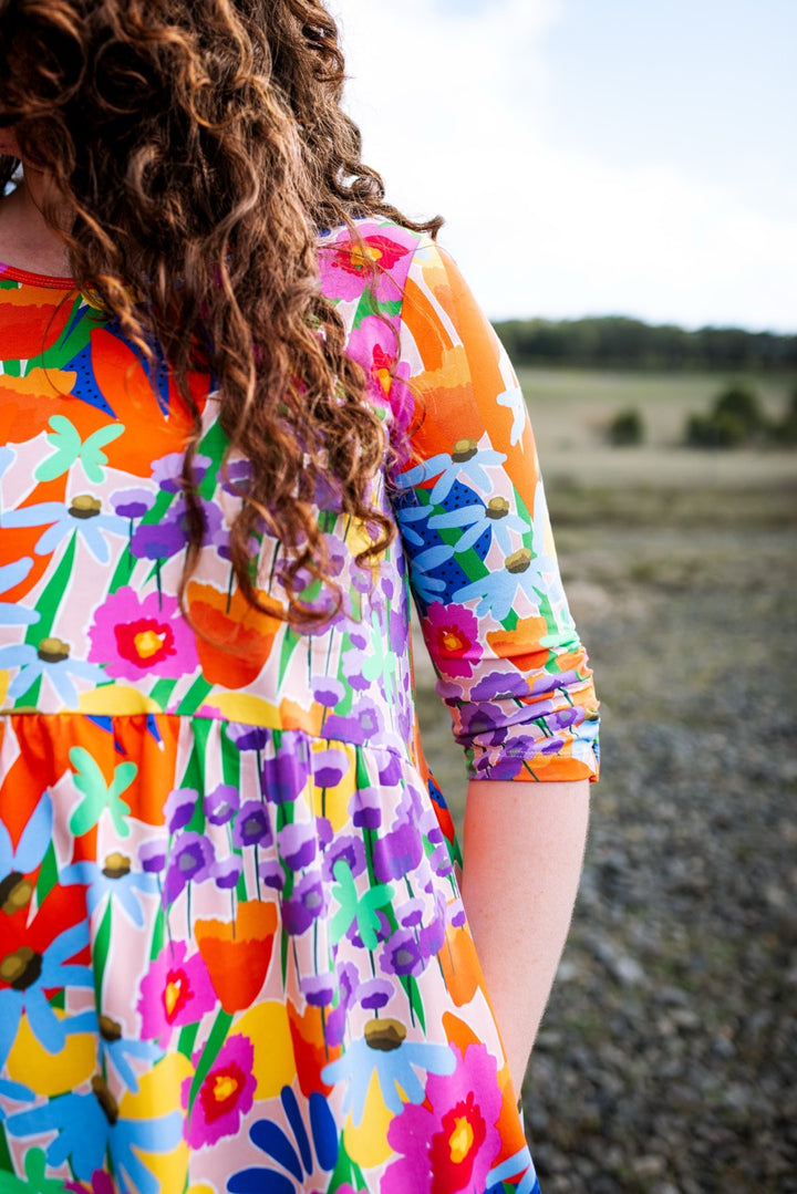 Close-up of the Ren Dress showing its original floral print and soft jersey drape